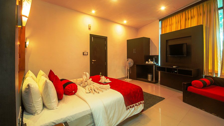 Image of a room with a bed and a television in front at Coorg Jungle Camp Backwater Resort, Kushalnagar.