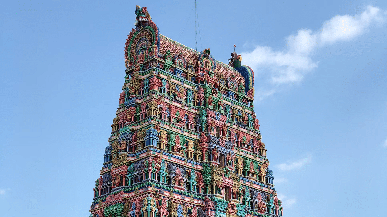 A temple facade with intricate carvings on the wall.