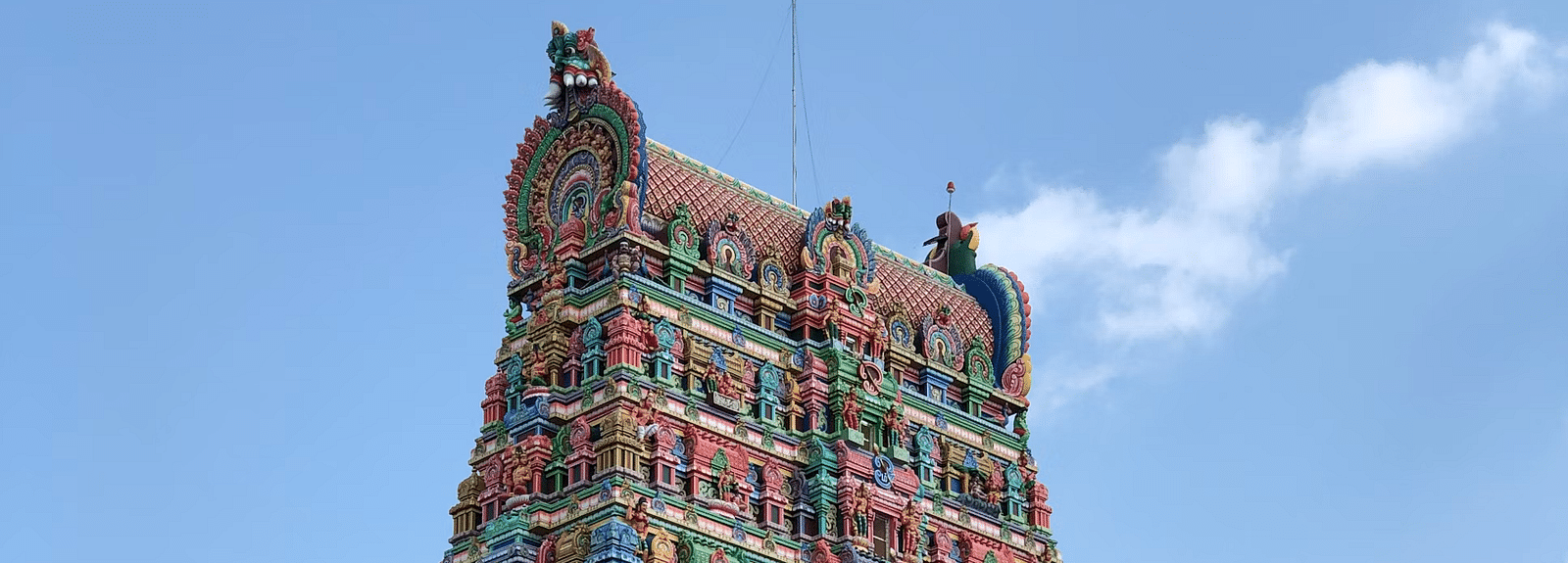 A temple facade with intricate carvings on the wall.