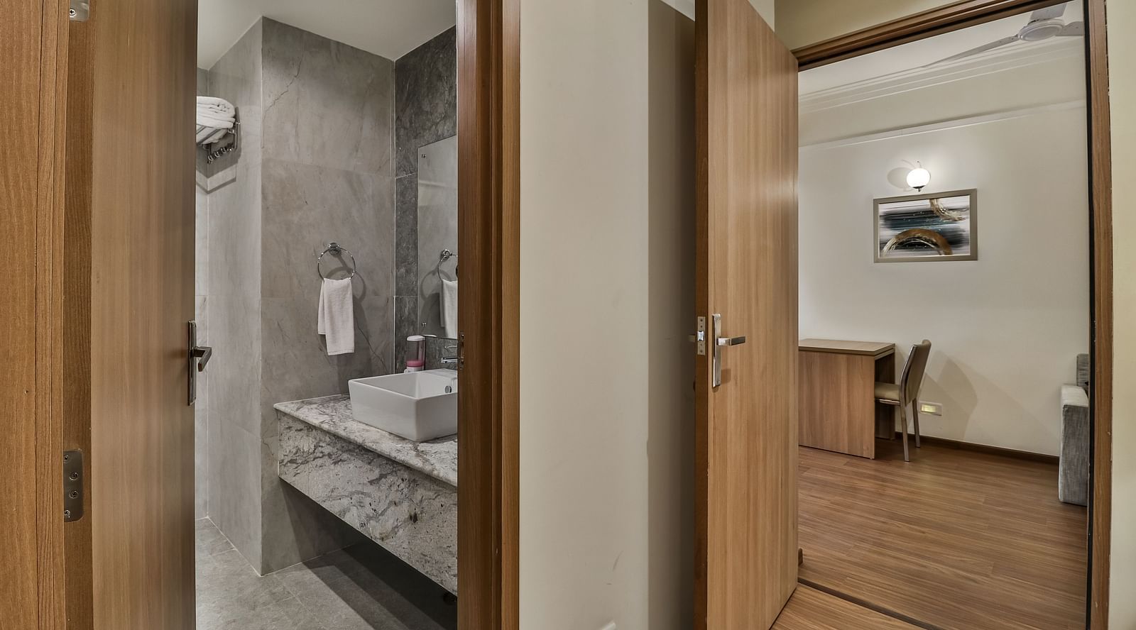 Bathroom and study table in view inside Deluxe Suite - Starlit Suites Newtown, Kolkata