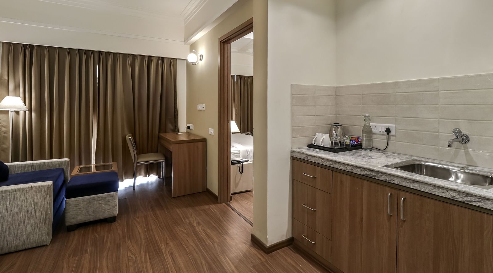 Living room and kitchenette in view inside Deluxe Suite - Starlit Suites Newtown, Kolkata