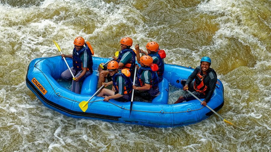Group of people riding blue raft on ganges river