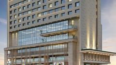 An exterior view of the Sarovar Premiere Alwar hotel building from a street perspective.