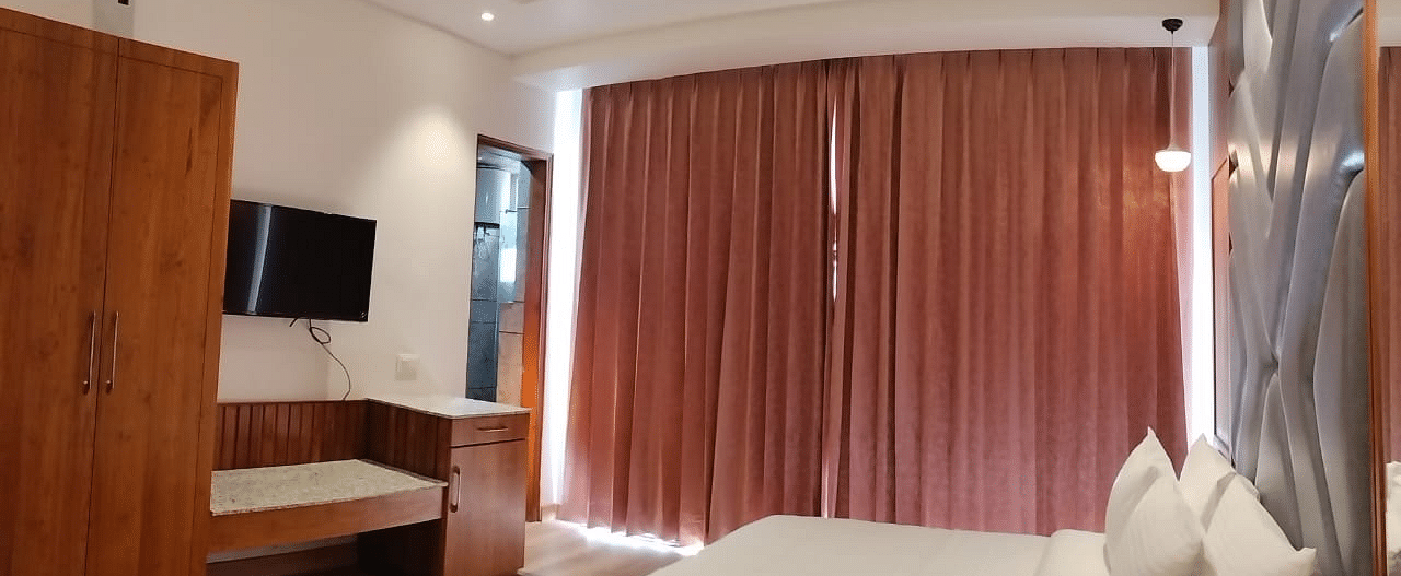 A large bed in front of the TV in Deluxe Non-view Room at DLS Ark Holiday Inn, Banikhet.