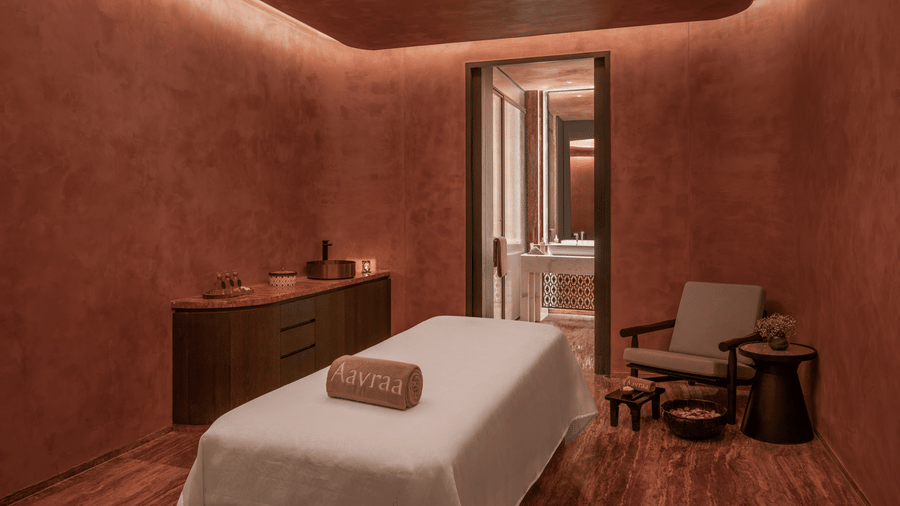 Spa treatment room with a single massage bed and warm toned walls at The Residency Signature Madurai.