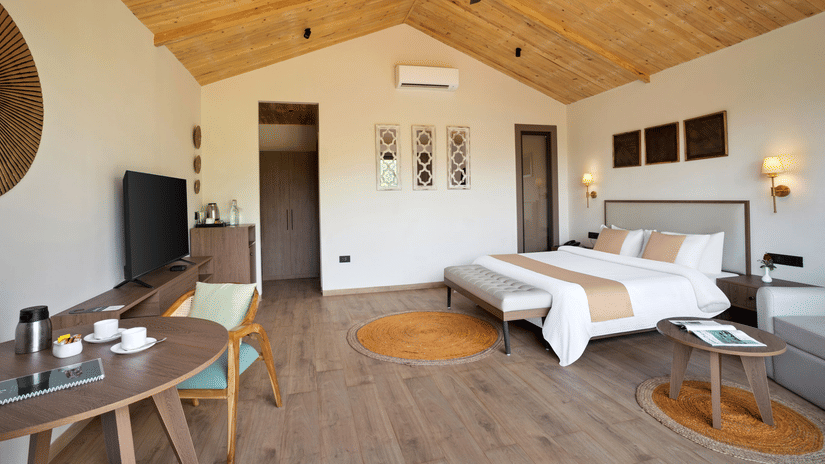 1 (1)A well-furnished bedroom with a king-size bed, wooden aesthetics, and an inviting ambiance.