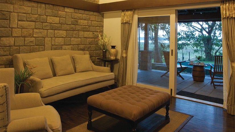 a seating area in one of the rooms at The Serai Kabini-17