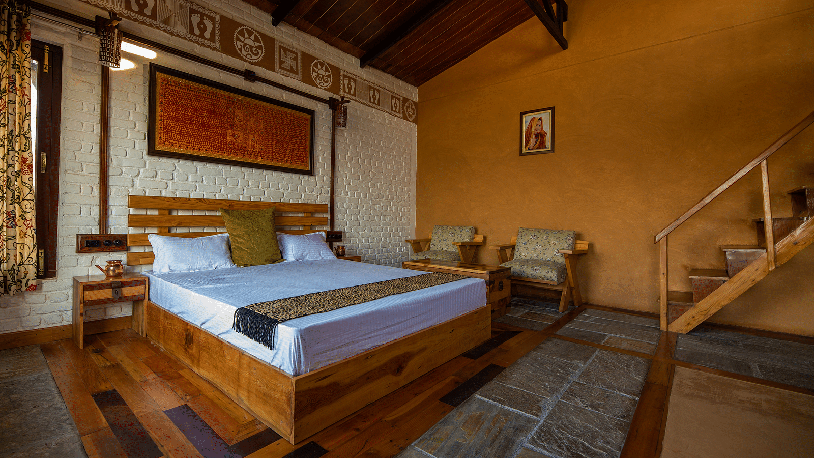 Rustic bedroom with wood bed, patterned textiles, and stairs to right. - Blusalzz Homes The Himalayan Bungalow, Almora