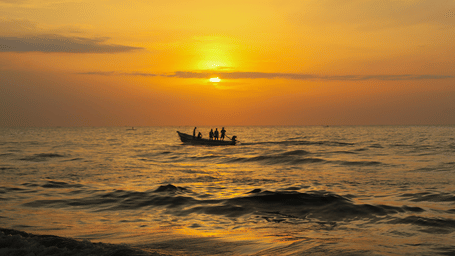 Auroville Beach, Pondicherry, sunrise view with a group of people on the boat in the Bay of Bengal. On you visit to Pondicherry in May, you can spend your time relaxing at this beach.
