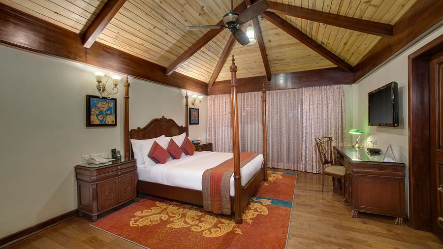 a king size bed facing a TV - Mayfair Spa Resort & Casino Gangtok 