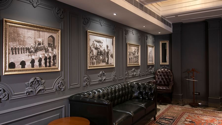 image of the dark grey photo wall at king george V board room at The Claridges New Delhi