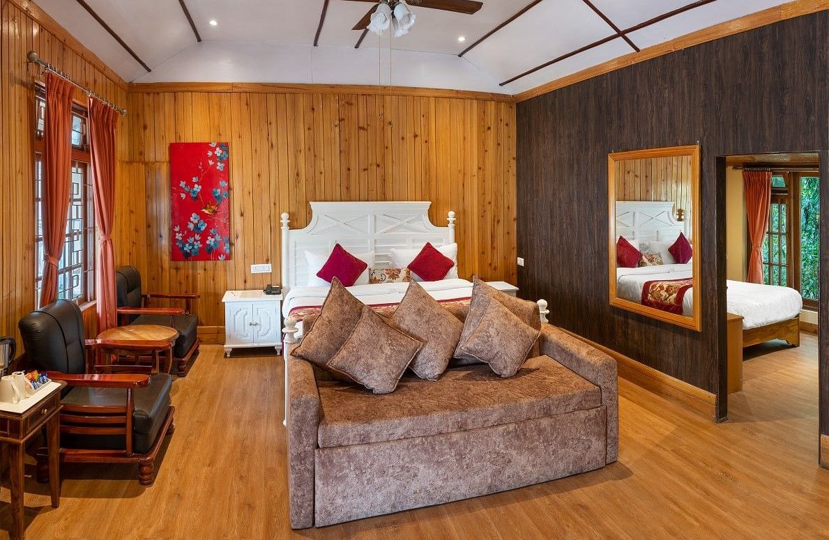 A room at Summit Barsana Resort & Spa, Kalimpong with a double bed 