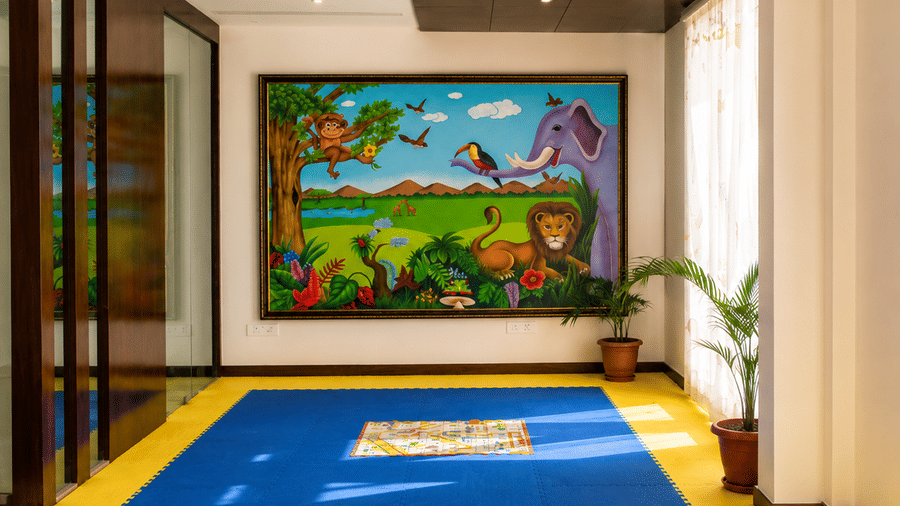Colourful indoor kids play area with soft flooring and a painted mural on the wall at Eastlynn Resort, Rishikesh.