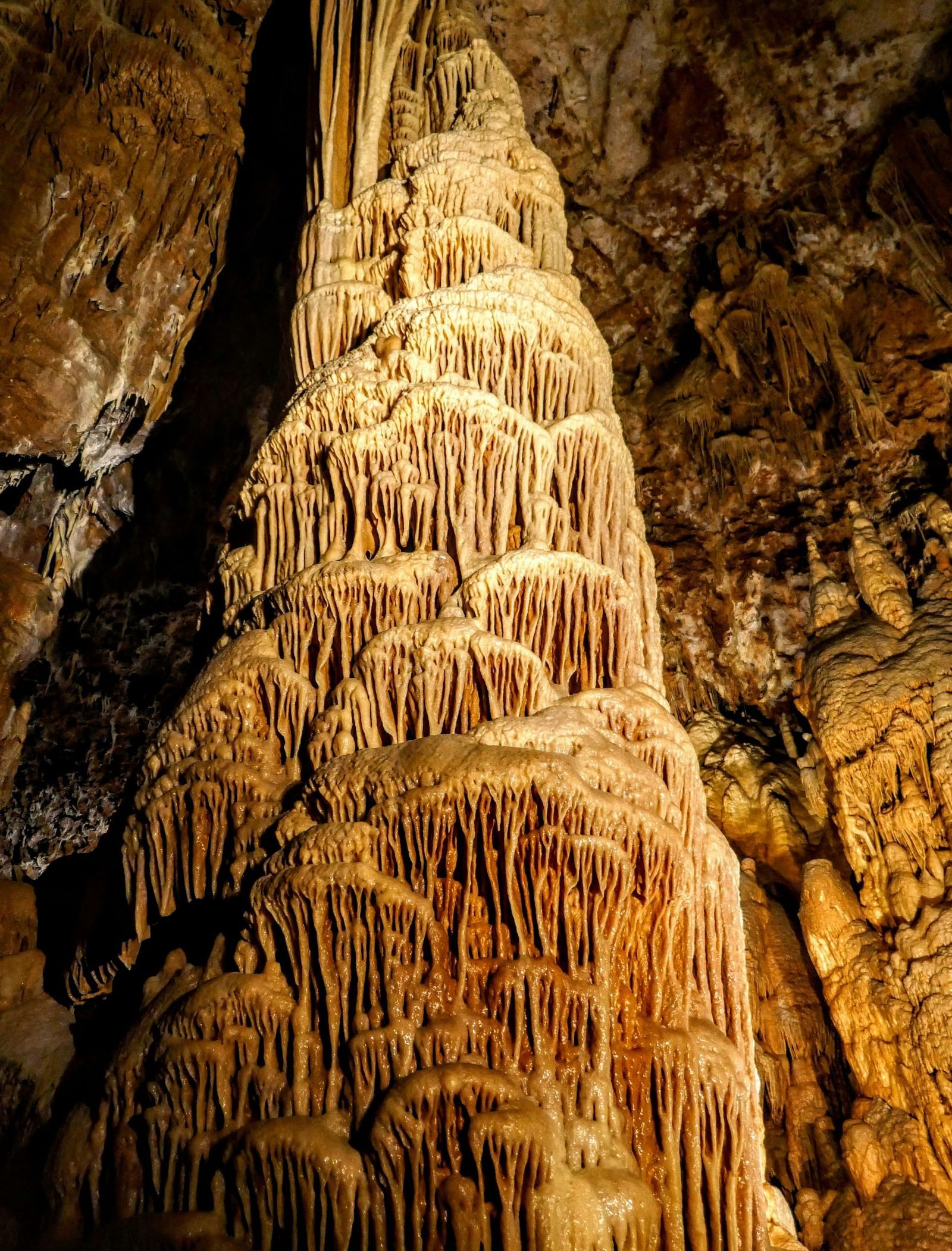 A large stalagmite formation inside a cave.