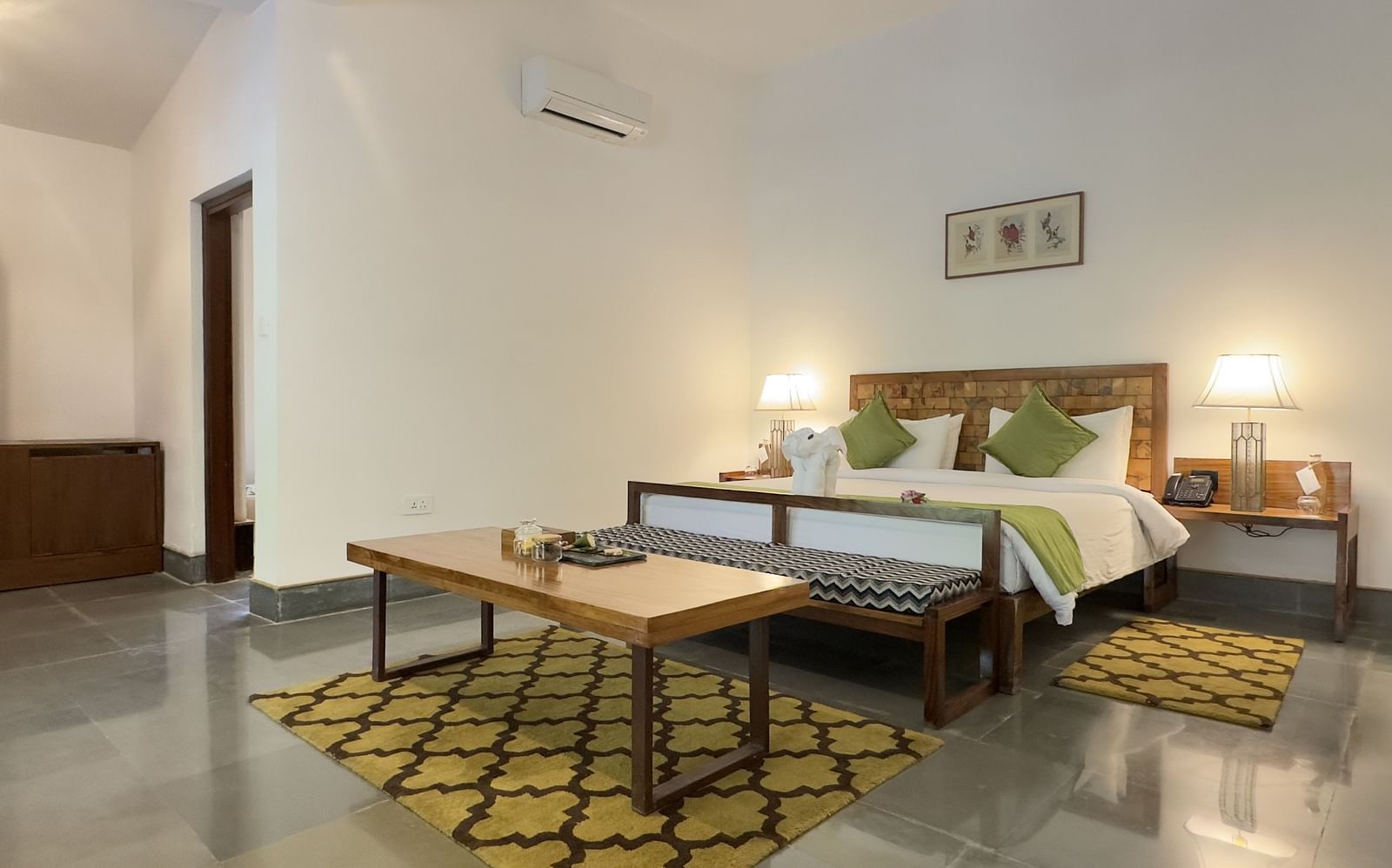 Sanctuary Suite at Saraca Resort & Spa Corbett with a double bed and a coffee table placed in front of the bed on a carpet