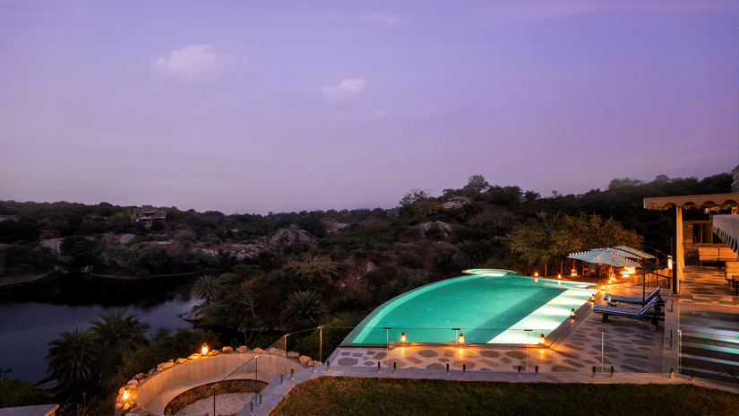 A view of the swimming pool with forest cover and a lake in the background - Chunda Shikar Oudi, Udaipur