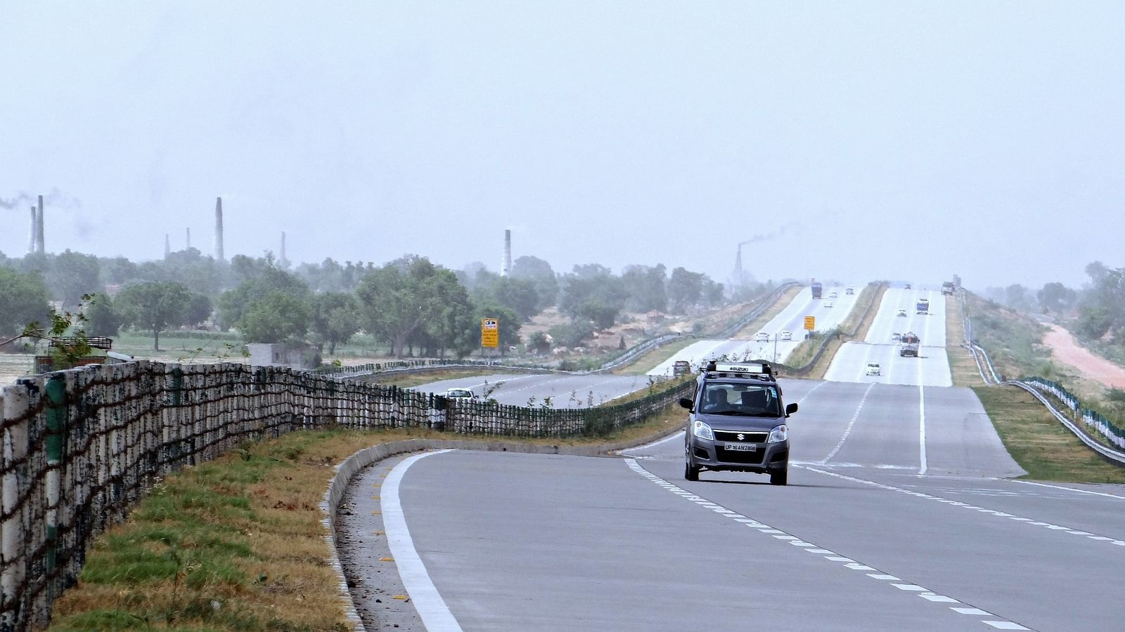 A close up of the Yamuna Expressway in Delhi with a vehicle travelling on the second lane.