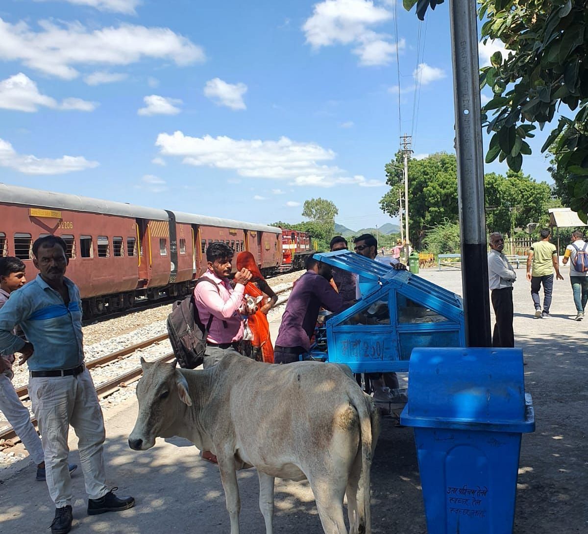 image showing some people waiting on a platform for a train to pass