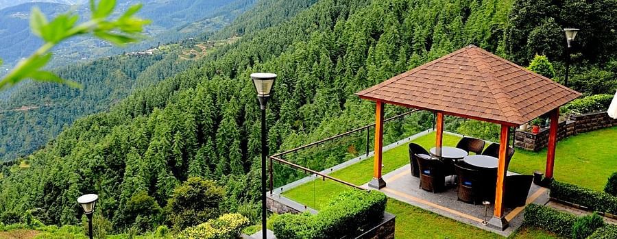 outdoor sitting area at Aranya surrounded by greenery - Aranya Himalayan Retreat, Mashobra