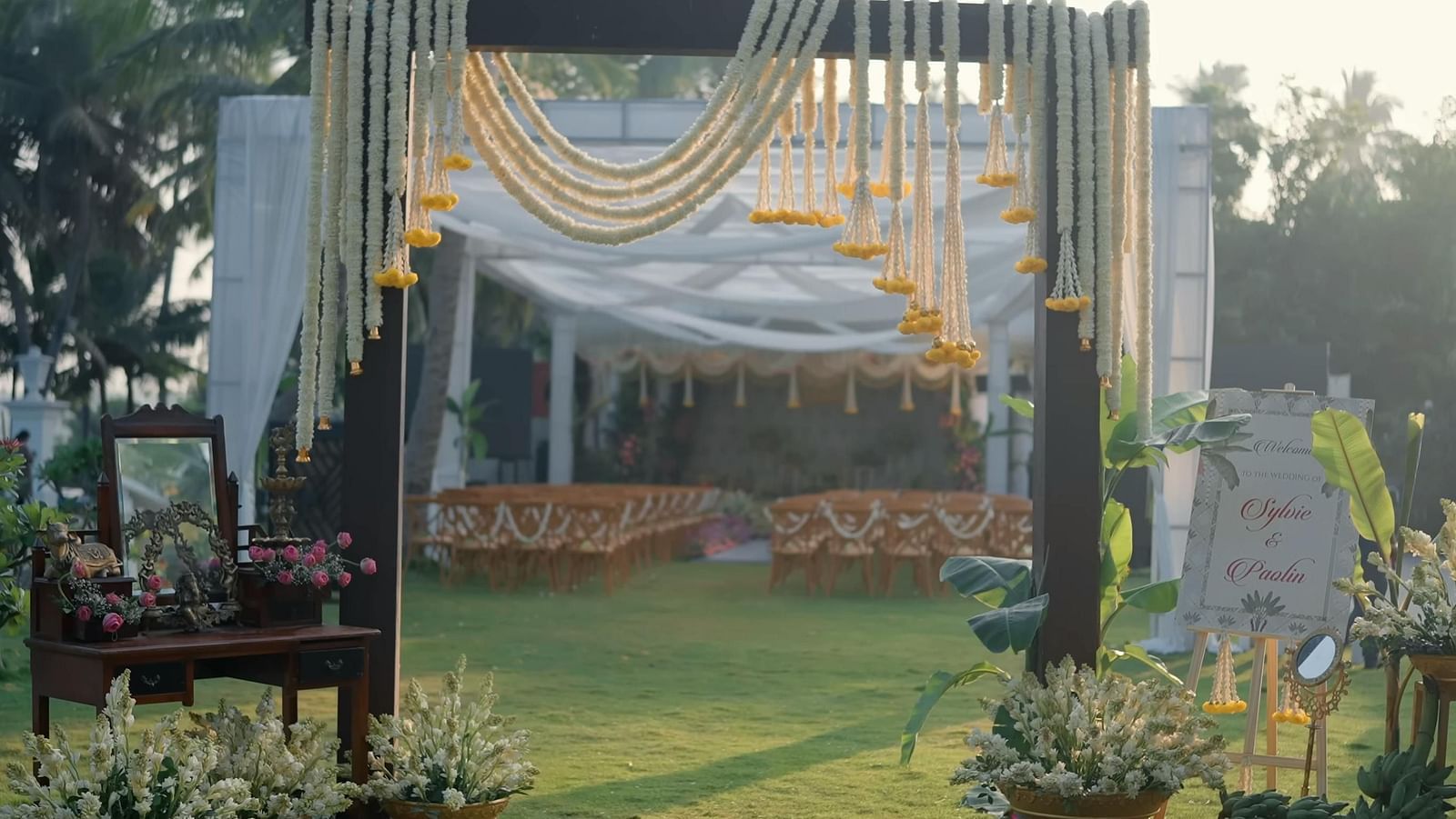 Outdoor wedding decor spread across a lawn.