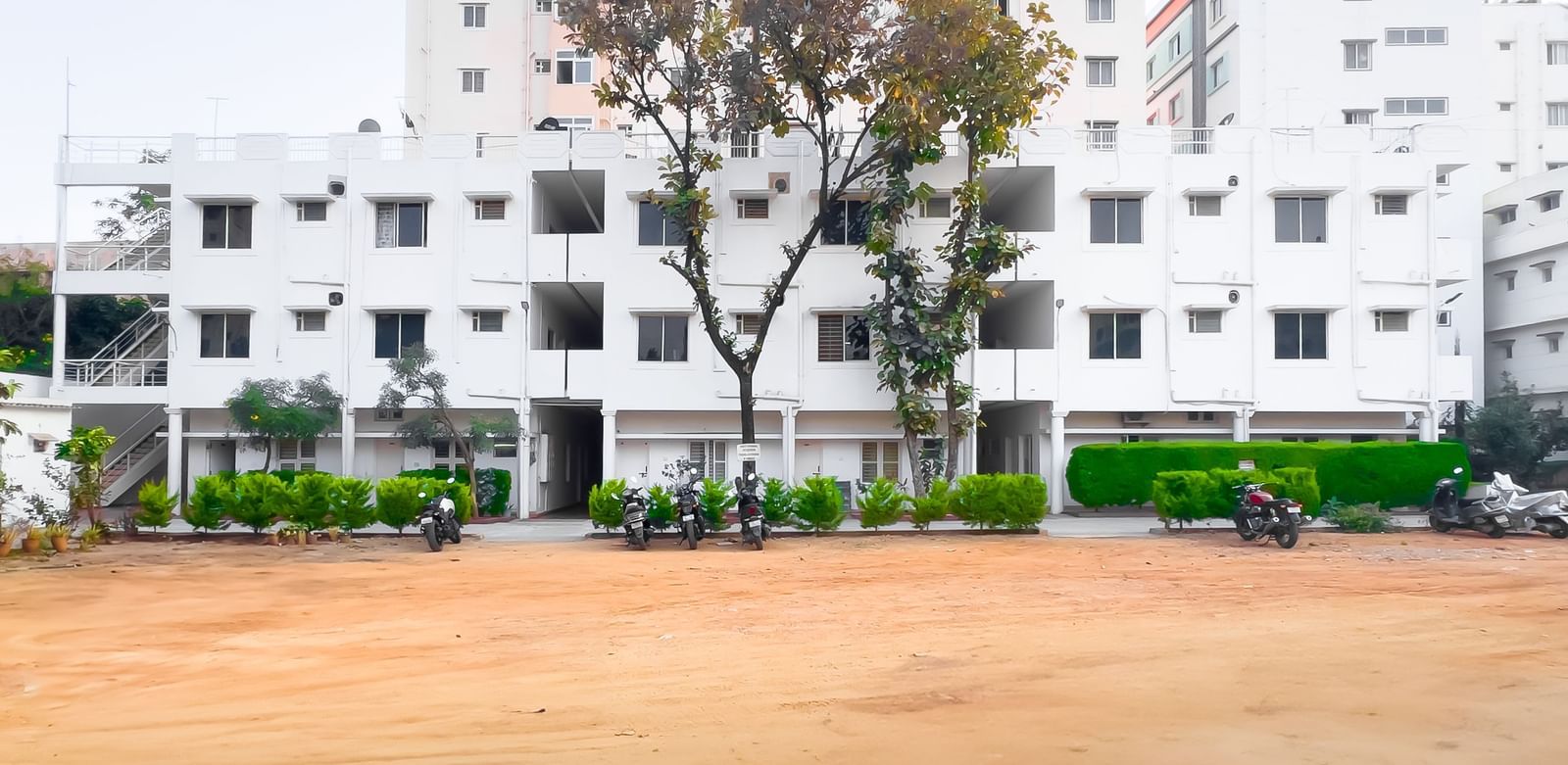 Wide outdoor area with apartment building in the background at The Pinnacle, Electronic City.