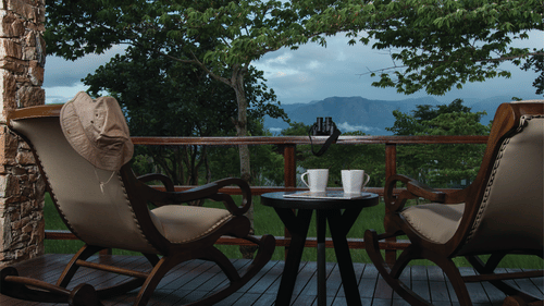 Private courtyard seating overlooking forested hills at The Serai Bandipur.