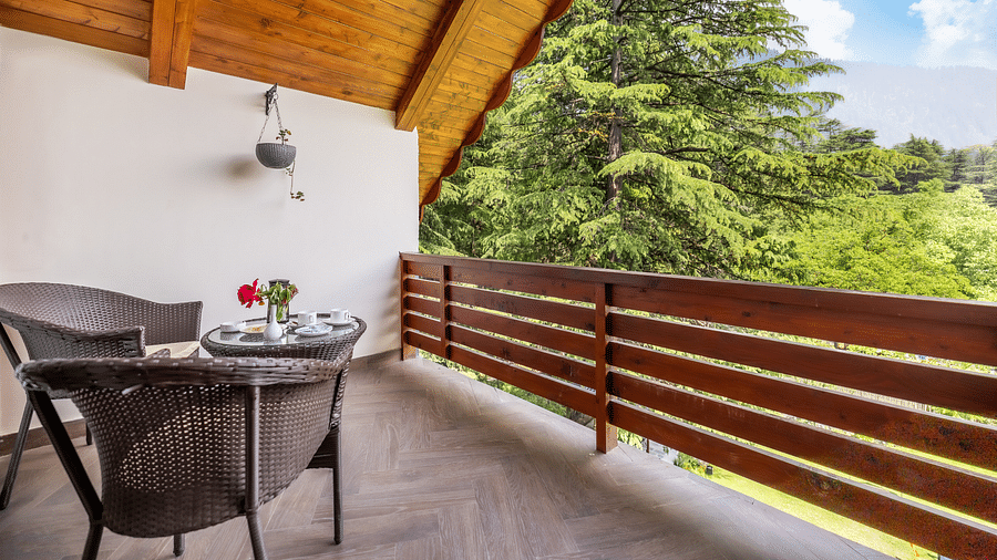 balcony of premium room with a chairs and a view at Bedzz Xclusive Baikunth, Manali