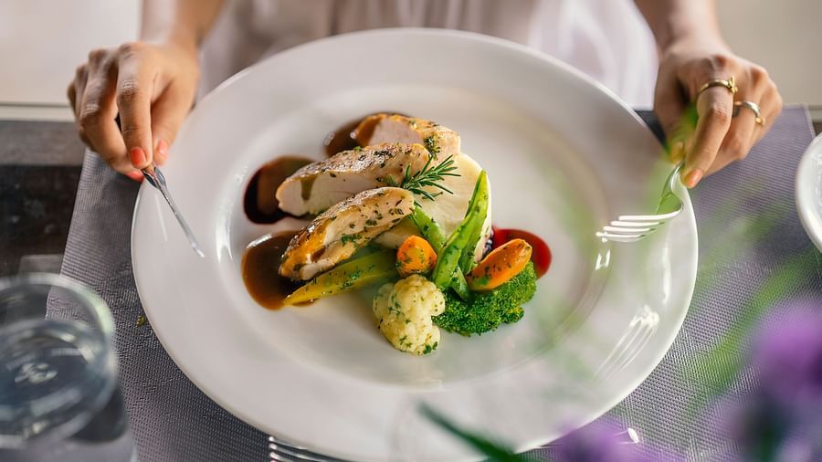 Close-up of a plated chicken dish with vegetables