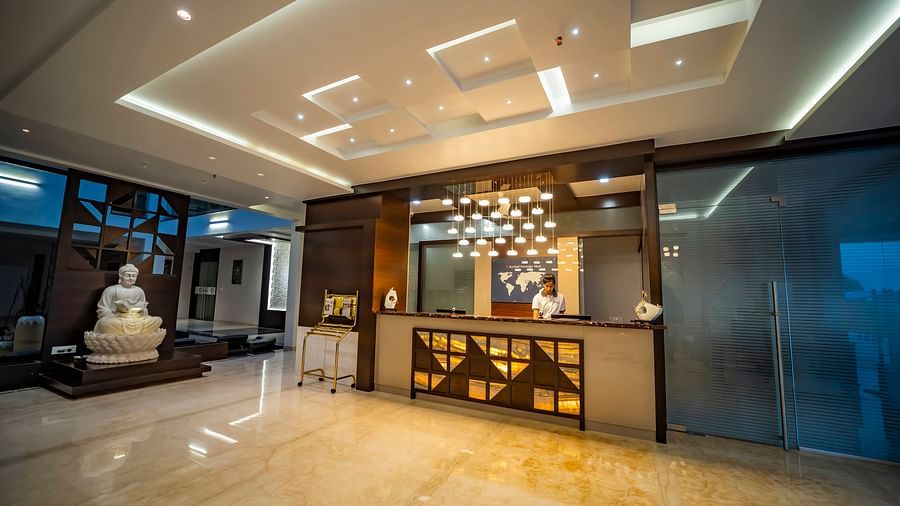 A picture of lobby with a front desk and a person to assist