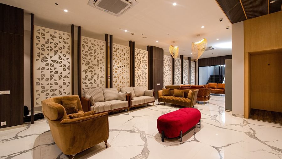 lavish lobby area with marbled floor and couches with air-conditioning on the ceiling - Mastiff Hotel, Ankleshwar