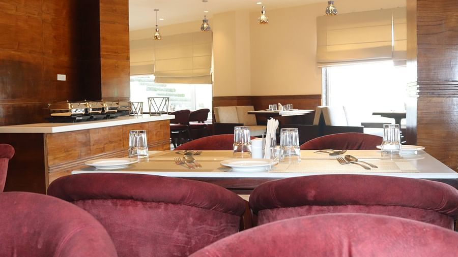 View of Tangelo restaurant with tables and partial view of chairs - Mastiff Hotel, Dalhousie 