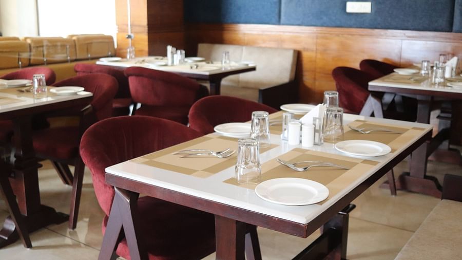 Side view of tables with modern interior designed in Tangelo - Mastiff Hotel, Dalhousie