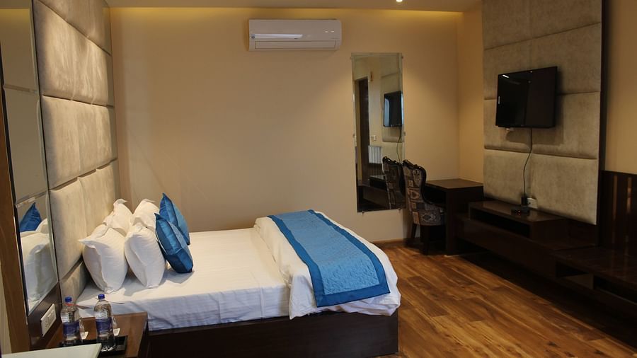Mastiff Hotel in Dalhousie presents a side perspective of a room featuring a comfortable, luxurious bed - Mastiff Hotel, Dalhousie