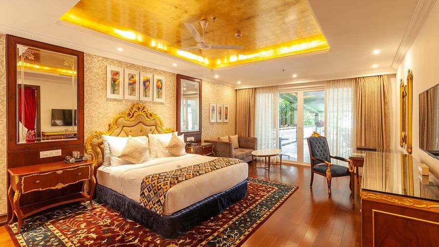 a king size bed facing the TV and a dressing mirror on its left - Mayfair Lake Resort, Raipur