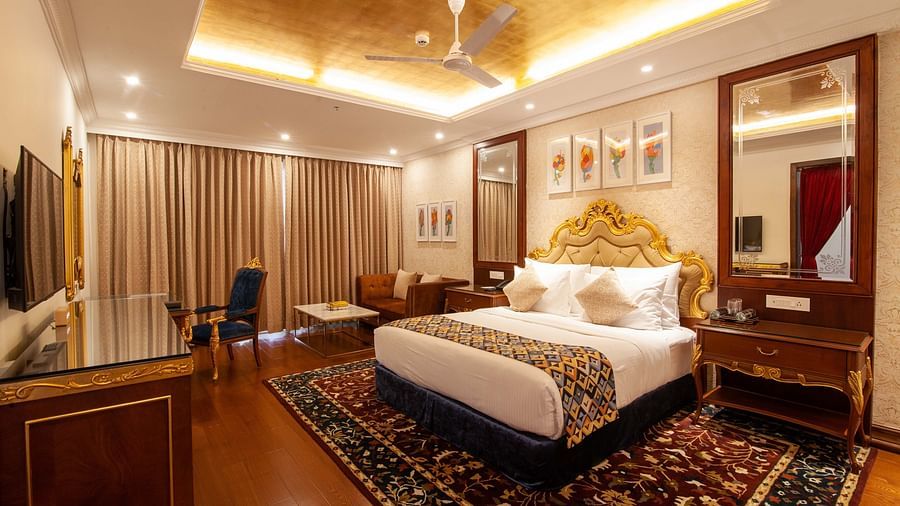 a king size bed facing the TV at one of the rooms - Mayfair Lake Resort, Raipur 
