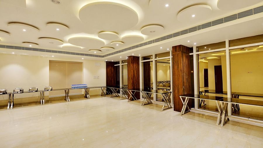 Spacious banquet hall with modern lighting and buffet setup.