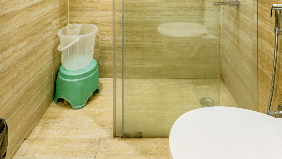 Hotel bathroom featuring a glass-enclosed shower area with modern fixtures.