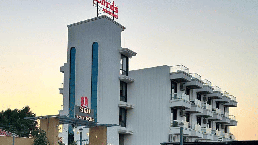 A contemporary hotel building stands tall against the evening sky, viewed from the entrance area - Lords SKD Resort, Salangpur