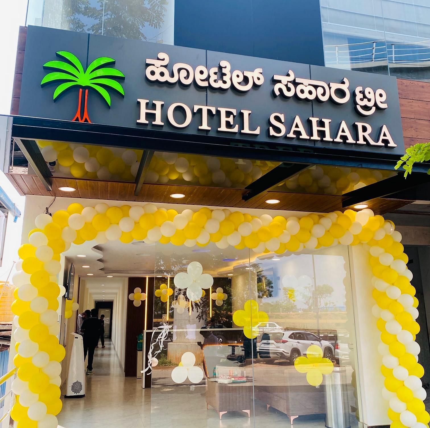 Entrance view with illuminated signage and welcoming entrance to Hotel Sahara Tree.