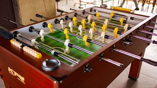 Indoor foosball table placed in a recreational area for guests' entertainment.