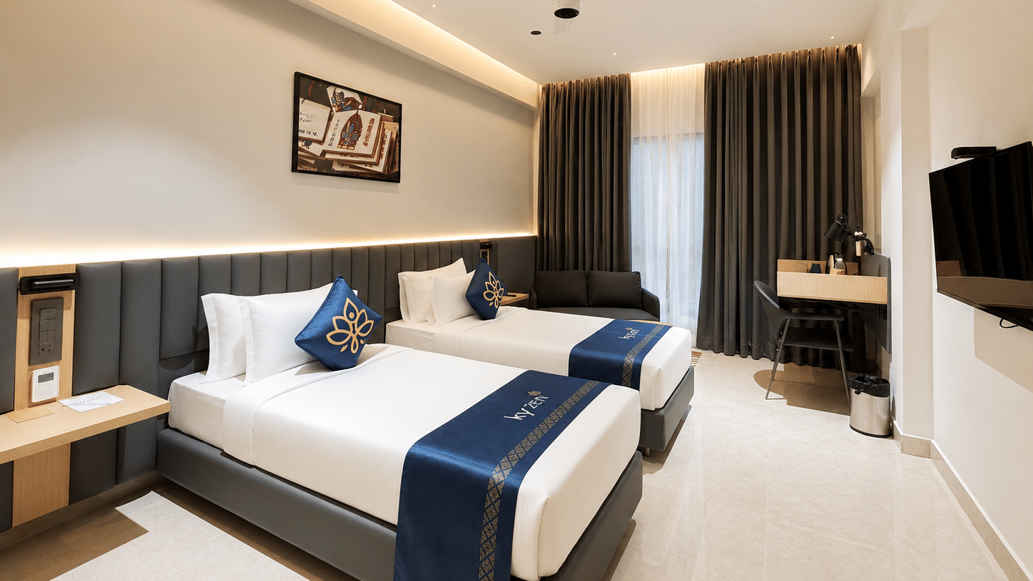 Premium Suite with two twin beds and a wall mounted television at Hotel Kyzen, Shamshabad Airport, Hyderabad.