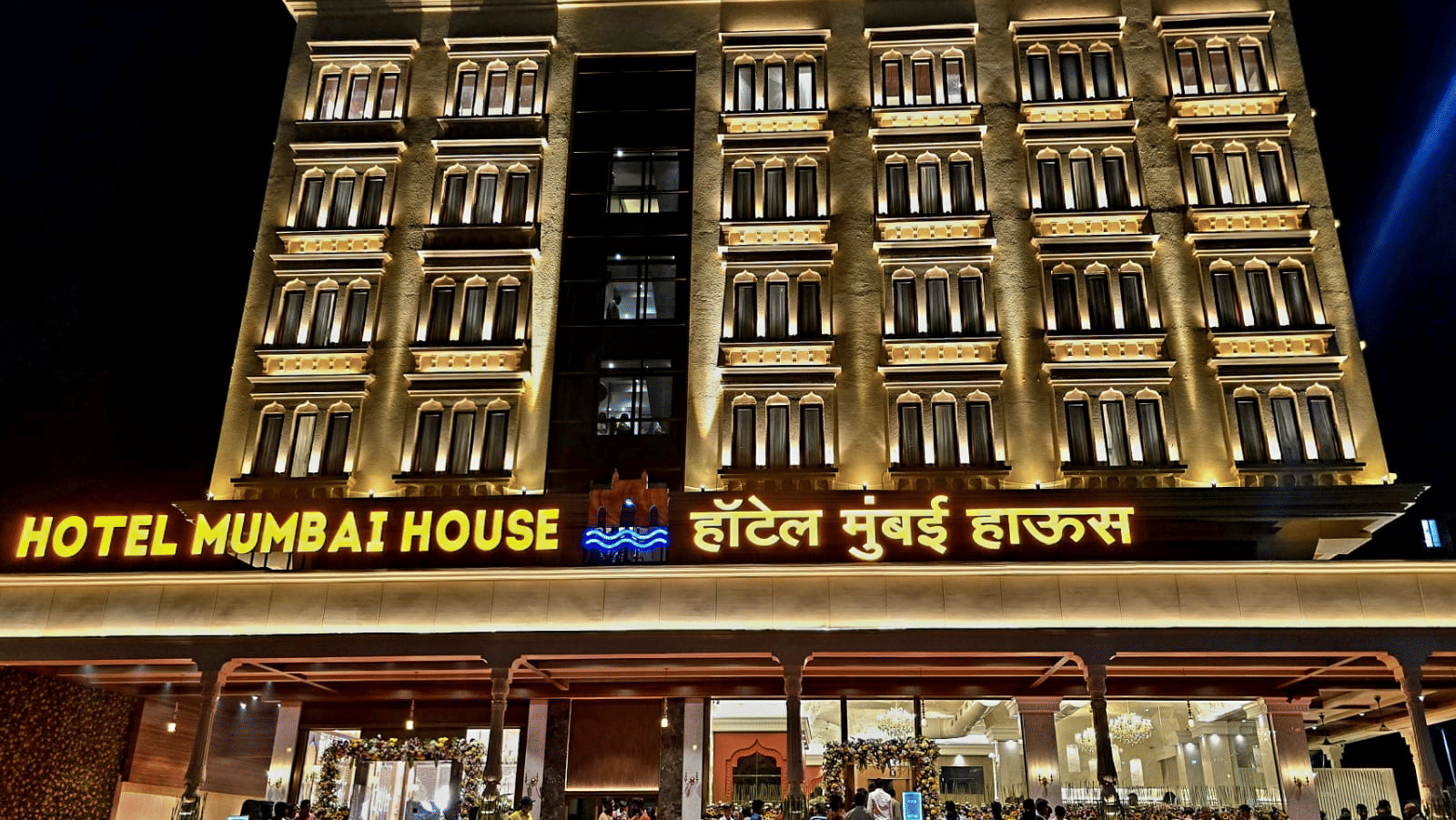 Illuminated hotel exterior at night showcasing grand façade at Hotel Mumbai House, Digha, Airoli.