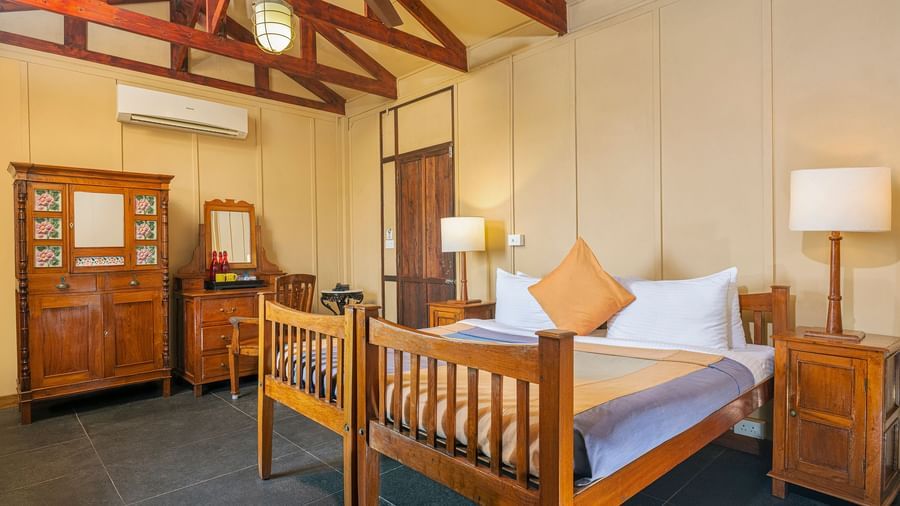 A double bed with side tables and lamps inside a Superior room | Mango Hill, Pondicherry