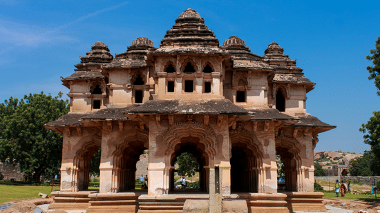 Facade of the Lotus Mahal at Hampi featuring its architecture under a clear blue sky