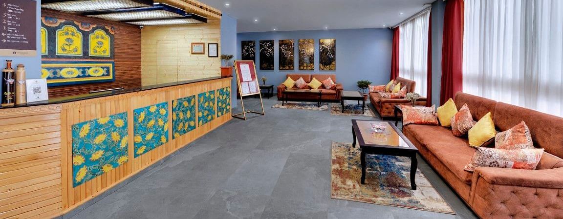 Image of the reception at the property with a cosy couch  | Yashshree Lachung