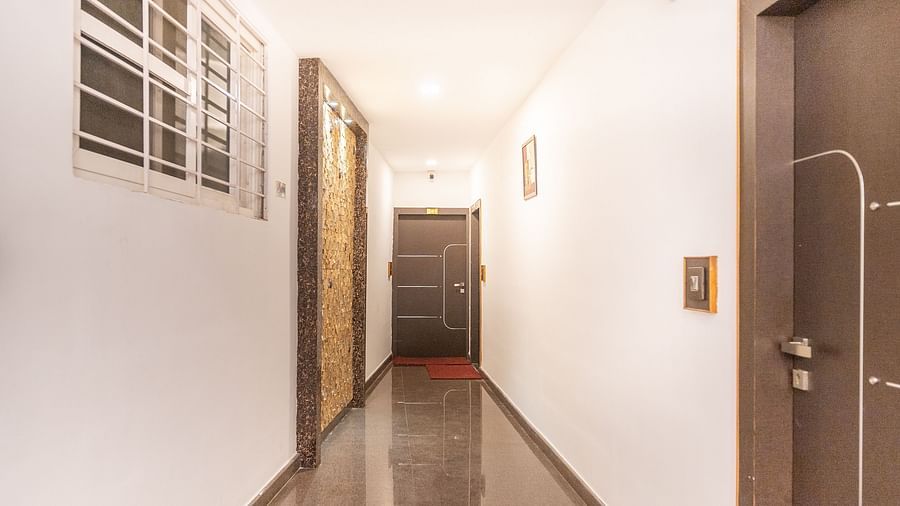 Image of a hallway with doors on both sides at Parampara Residency, Kushalnagar.