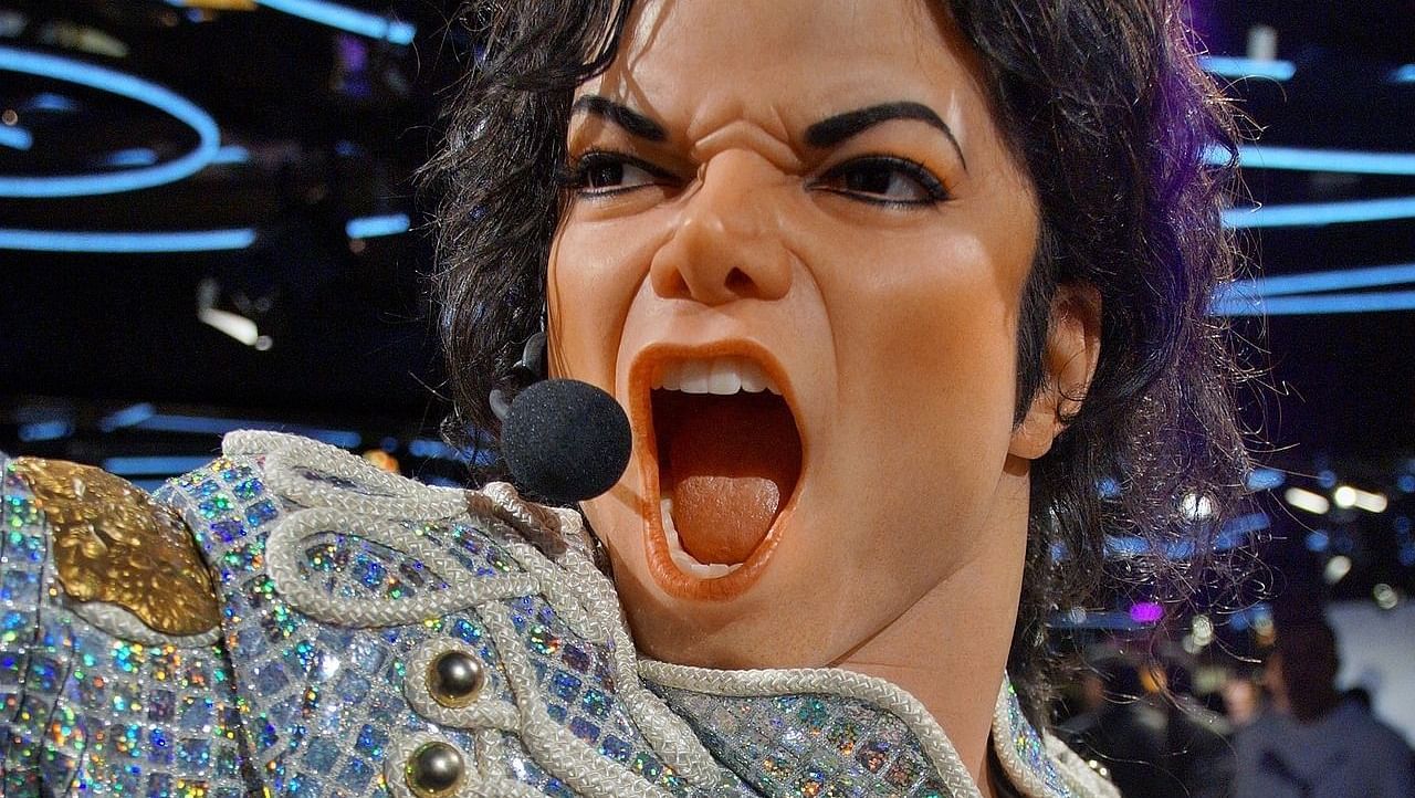 A wax figure of Michael Jackson in mid-performance with a microphone headset