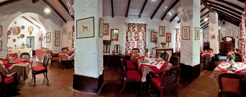 Full view of dining area with chairs and tables - Ramgarh Bungalows, Nainital.