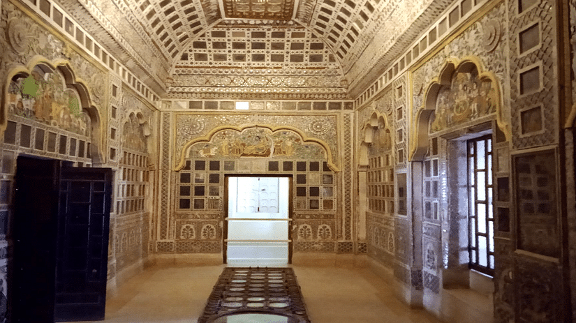 A beautiful interior view of Sheesh Mahal, showcasing its stunning mirror work, intricate designs, and elegant architecture that reflect a rich historical ambiance.