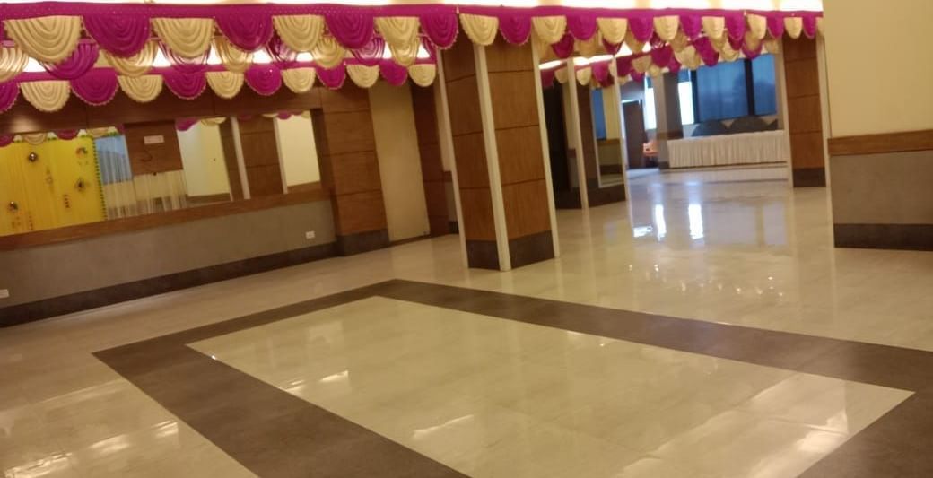 Banquet hall decorated with pink and white ceiling drapes at Max Hotel Prayagraj.